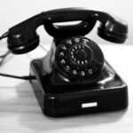 black rotary phone on white table